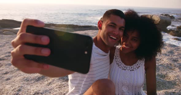 Couple taking selfie with mobile phone on the beach 4k