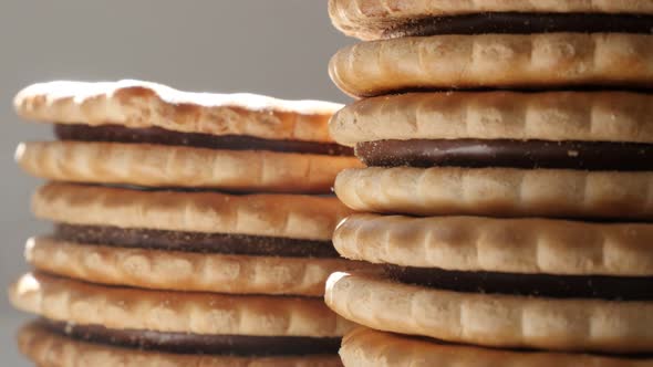 Pile of chocolate cream  filled sandwich cookies close-up  slow tilt 4K 2160p 30fps UltraHD footage  alt
