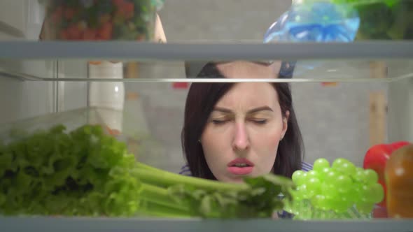 Dissatisfied Female Feels an Unpleasant Smell in the Refrigerator alt