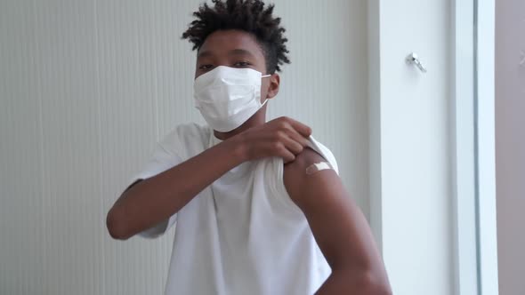 African American Teenager Showing COVID19 Vaccine Bandage Merrily alt