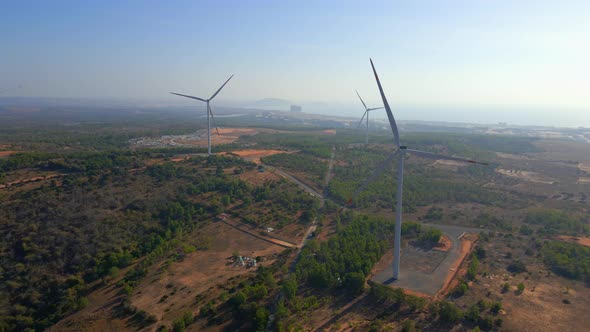 Aerial Shot of a Group of Wind Turbines in a Semidesert Environment alt