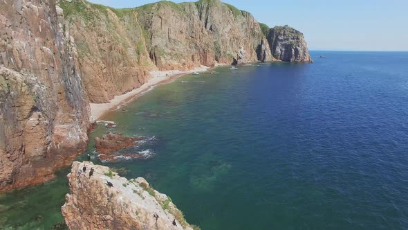 View From a Drone of the Coastline with a Rocky Coast and Hight Cliffs alt