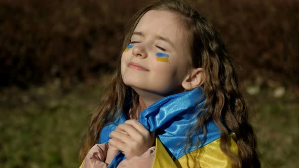 Girl 910 Years Old with the Ukrainian Flag on Her Shoulders