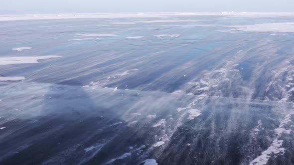 Snow Is Flying Over Surface of Blue Ice of Lake Baikal