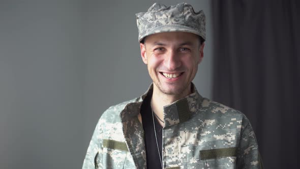 Portrait of a Man in Military Fatigues Face to Camera
