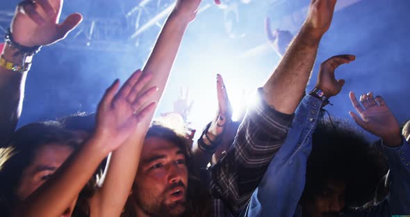 Group of people dancing at a concert 4k alt