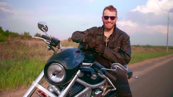 Portrait of a Biker on a Motorcycle Chopper with Sun Glasses