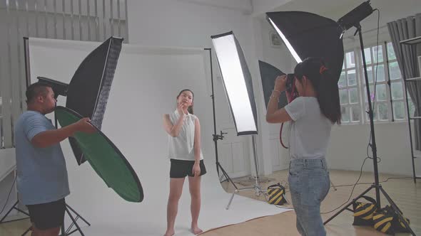 Behind The Scenes On Photo Shoot: Beautiful Asian Model Poses For A Photographer, She Takes Photos alt