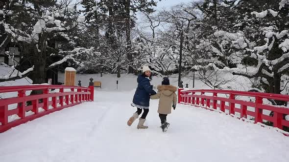 Asian Children Holding Hand And Running Together On Red Bridge alt