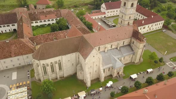 Aerial Circle Panning Shot of Eastern European orthodox church (Romania) with clock on the front and alt