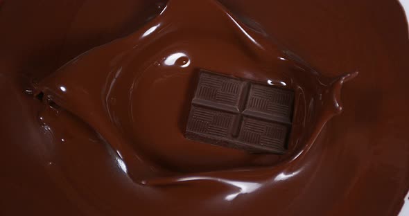 Black Chocolate tablet falling into Milk Chocolate, Slow Motion 4K alt