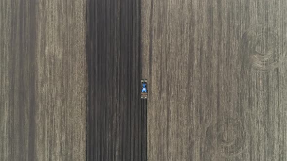 Aerial view of a blue tractor plant potatoes. 06 alt