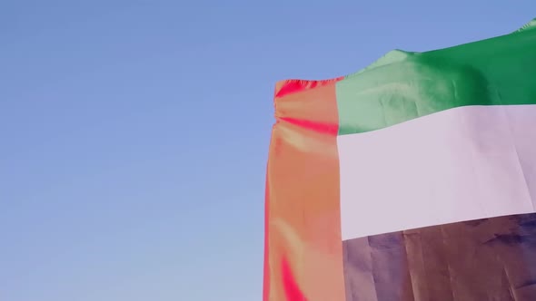 United arab emirates flag on the shoulders of a young brunette woman