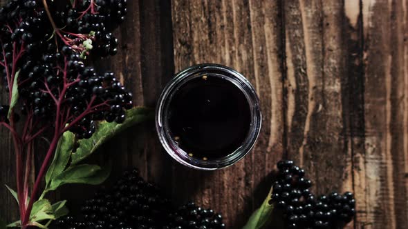 Natural Elderberry Juice Top View. Black Elderberry Berry On A Wooden Background. Herbal Medicine.