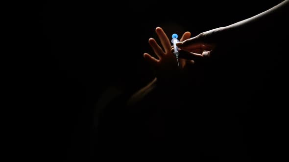 Addicted Female Taking Syringe With Narcotic From Drug Dealer Hands in Darkness alt