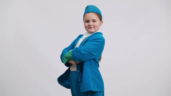 Side View Confident Proud Caucasian Girl in Stewardess Uniform Crossing Hands Looking at Camera alt