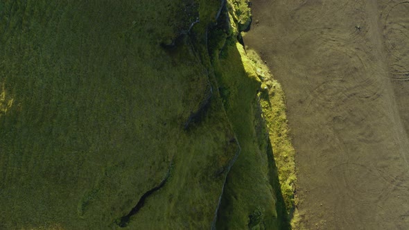 Flying over mountain coast, birdview. Green nature, green plain, from coast to mountain. alt