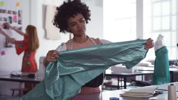 Mixed race woman working in fashion office alt