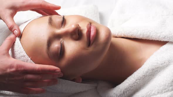 Spa Woman Facial Massage. Face Massage in Beauty Spa Salon. Female Enjoying Relaxing Face Massage in