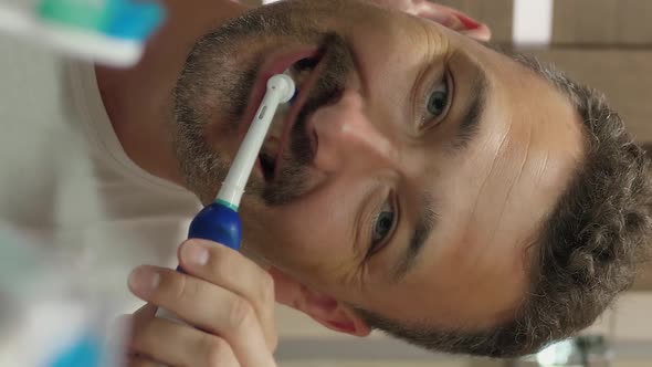 Vertical Video of Guy Brushes Teeth