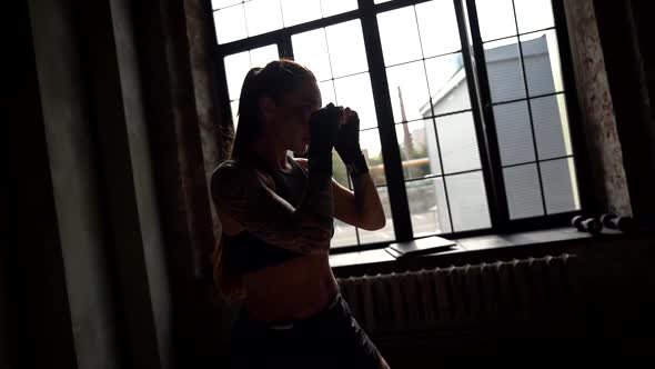 Graceful Sportswoman Is Training Legs Strikes During Kickboxing Training alt