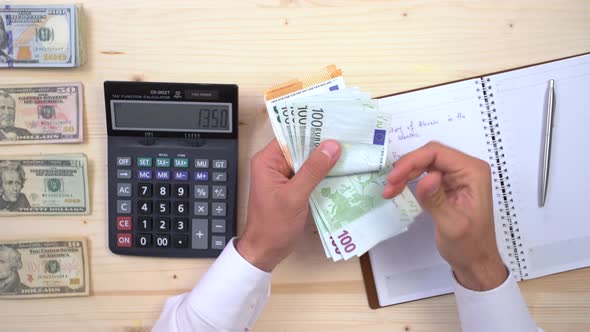 Counting euros at an accountancy office alt