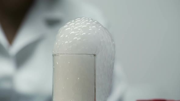 Thick Bubble Foam Coming Out of Neck of Chemical Flask, Cosmetology Research alt