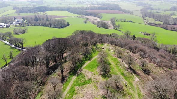 Aerial forward view looking over the Iron Age Fort of Hembury in Devon England on a sunny day alt