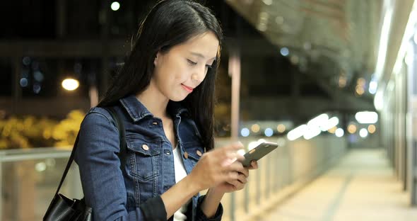 Woman looking at mobile phone  alt