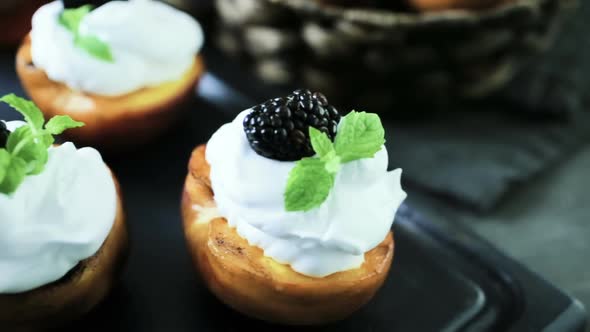 Grilled organic peaches with whipped cream, and garnished with fresh mint. alt