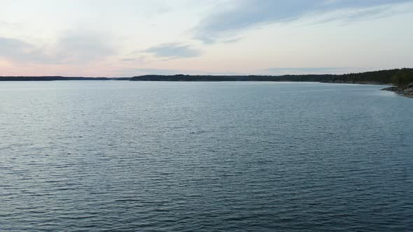 Aerial view over the calm sea of the Gulf of Finland and silhouette coast of Porkkala bay, on a sunn alt