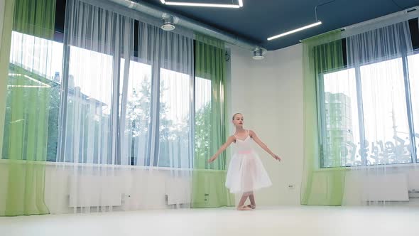 Girl in Skirt Dances Classical Ballet in Studio alt