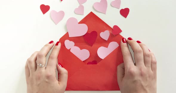 Man hand give envelope with flying hearts to woman hands Stop motion animation
