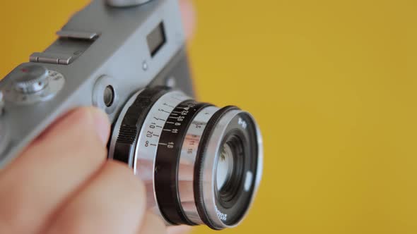 Close up Photographer Hold Vintage Film Camera in Hands.