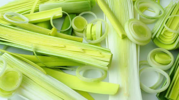 Green stems of cutted leeks isolated on white background 