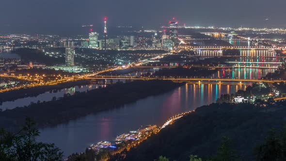 Skyline of Vienna From Danube Viewpoint Leopoldsberg Aerial Night Timelapse alt