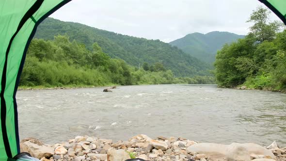 Beautiful View From the Tent on the Background of a Beautiful Mountain River alt