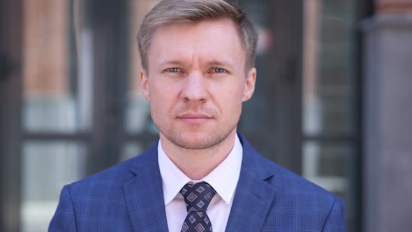 SErious Businessman Looking At Camera alt