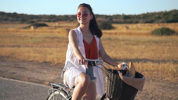 Gorgeous Confident Woman in Sunglasses with Bike Looking Around Admiring Beauty of Cyprus Nature at alt