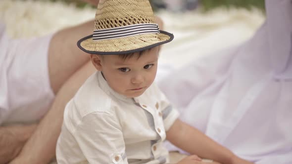 A Little Beautiful Boy in Light Clothes Is Sad