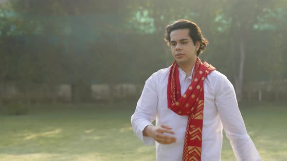 Confident Indian man walking in and out of the frame in a traditional outfit Kurta pajama alt