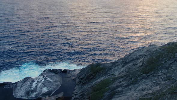 Drone flying above a secluded islandʻs beautiful tide pools during the sunrise alt