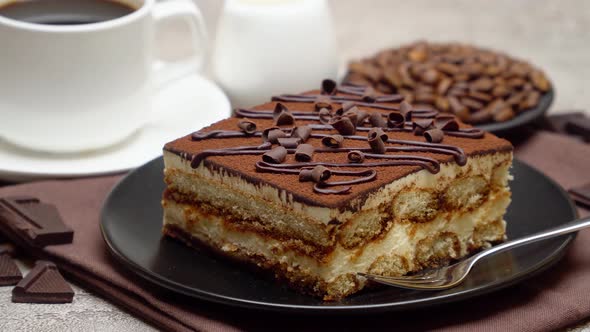 Portion of Traditional Italian Tiramisu dessert, cream or milk and cup of espresso coffee alt