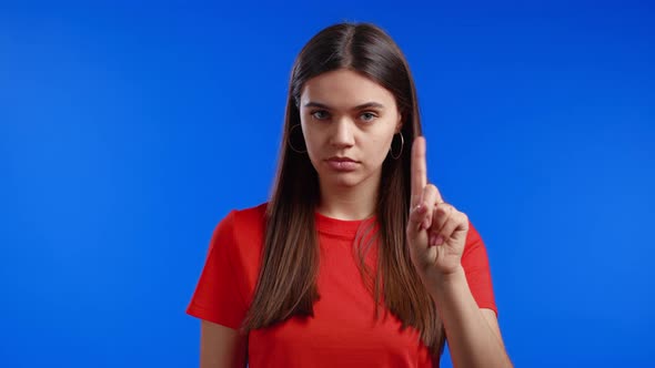 Portrait of Serious Woman Showing Rejecting Gesture By Stop Finger Sign alt