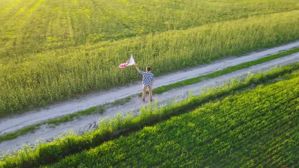 Man Holds Waving American Flag alt