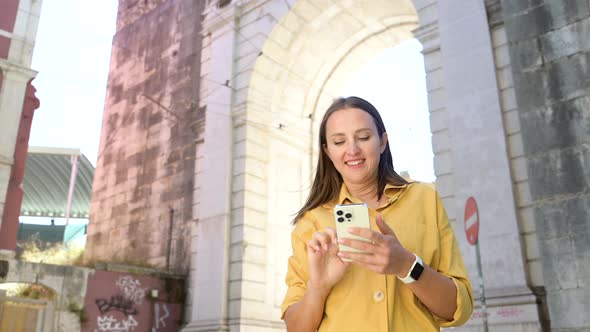 Lifestyle Portrait of Happy Foreign Woman Tourist Taking Photo with Smartphone During Sightseeing