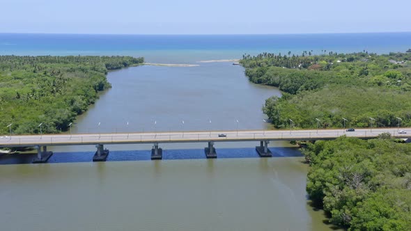 Bridge crossing the Soco river close to the river mouth, aerial fly over alt