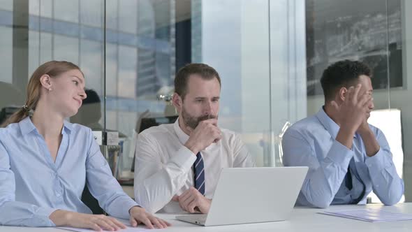 Business People Get Disappointed While Using Laptop on Office Table  alt