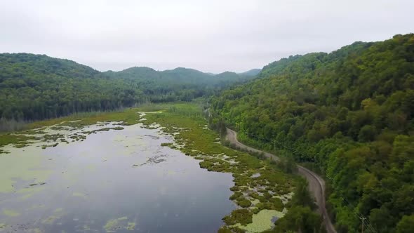 Drone Flying Above Green Hilltops alt