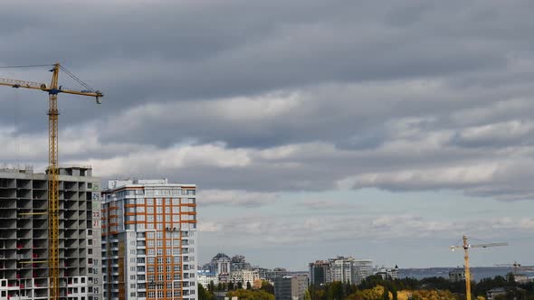 Unfinished multistory buildings time lapse with floating clouds in overcast sky